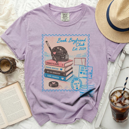 Lavender t-shirt with "Book Boyfriend Club" graphic featuring hockey elements.