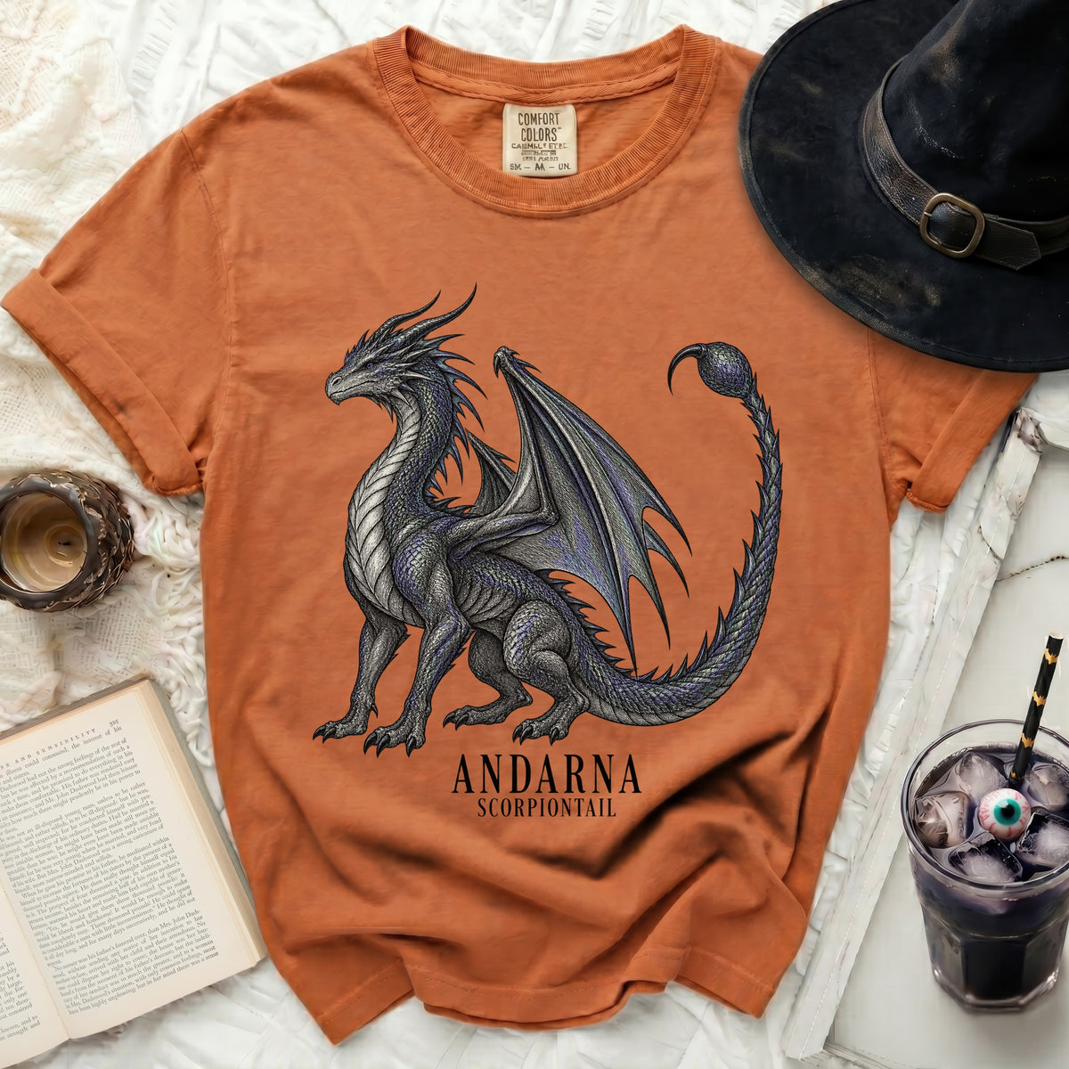 Orange t-shirt with a dark dragon graphic and text "ANDARNA SCORPIONTAIL".