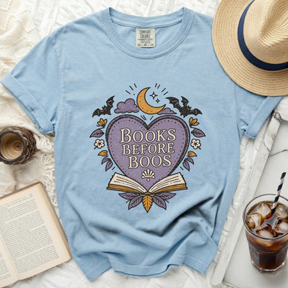 Light blue t-shirt with "Books Before Boos" graphic featuring a heart, moon, bats, and book.
