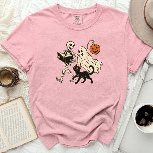 Pink t-shirt with skeleton, ghost, jack-o-lantern, and cat graphic.