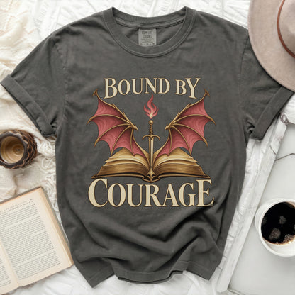Charcoal t-shirt featuring a fantasy design with a sword, open book, dragon wings, and the text Bound by Courage.
