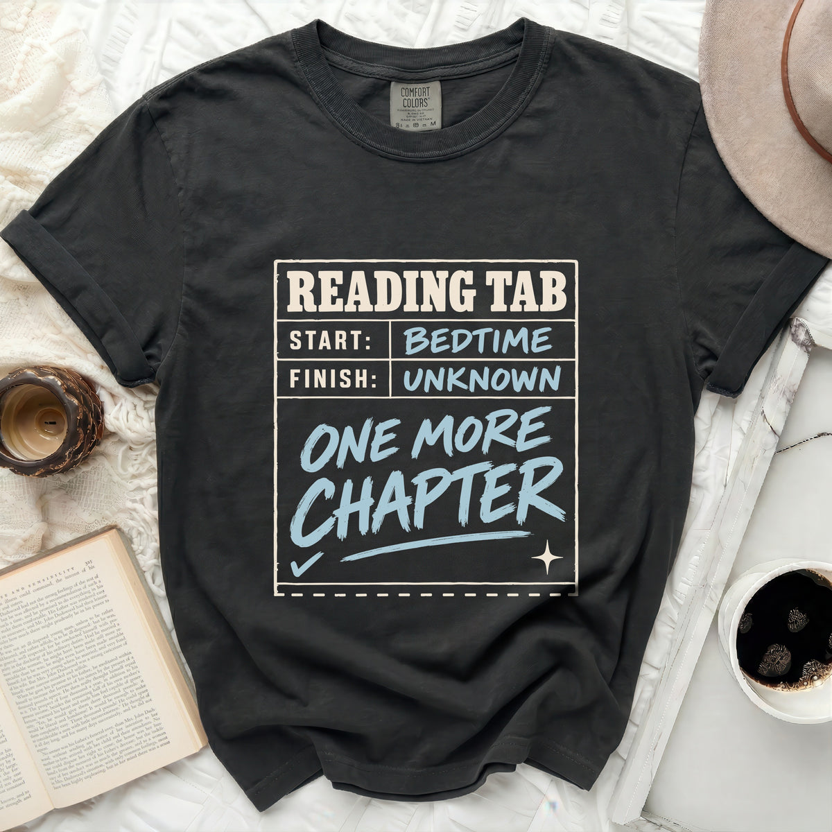 Black t-shirt with "Reading Tab: Start: Bedtime, Finish: Unknown, One More Chapter" graphic.