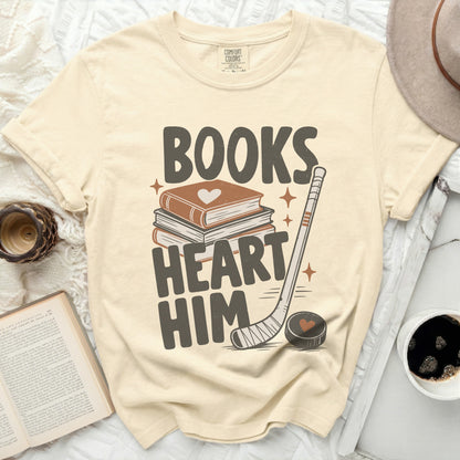 Cream t-shirt with "Books Heart Him" text, books, and hockey stick graphic.