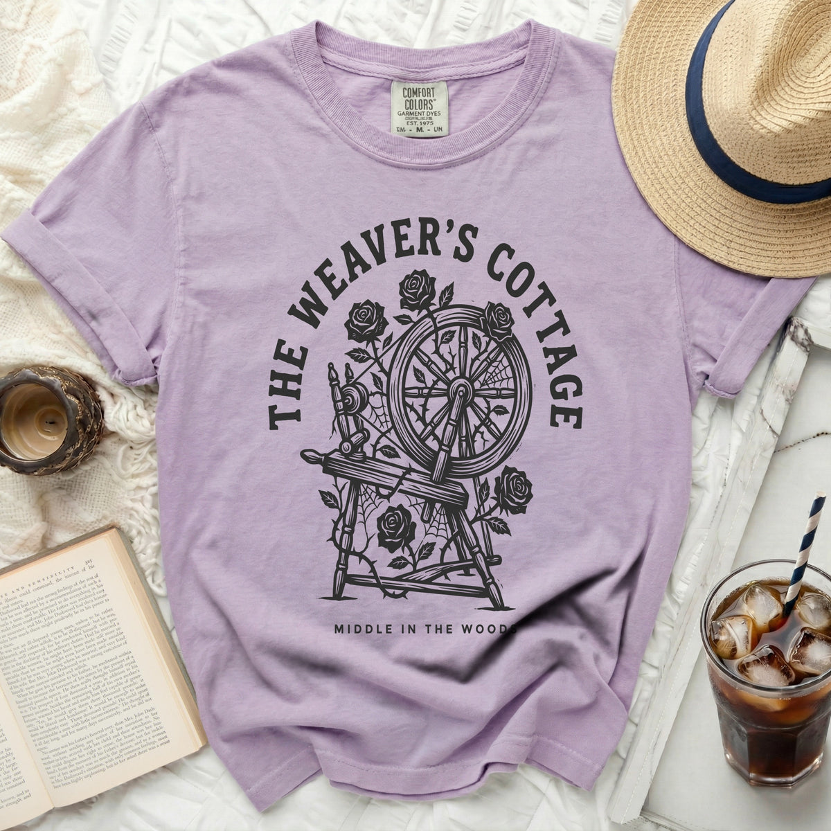 Lavender t-shirt with "The Weaver's Cottage Middle in the Wood" graphic.