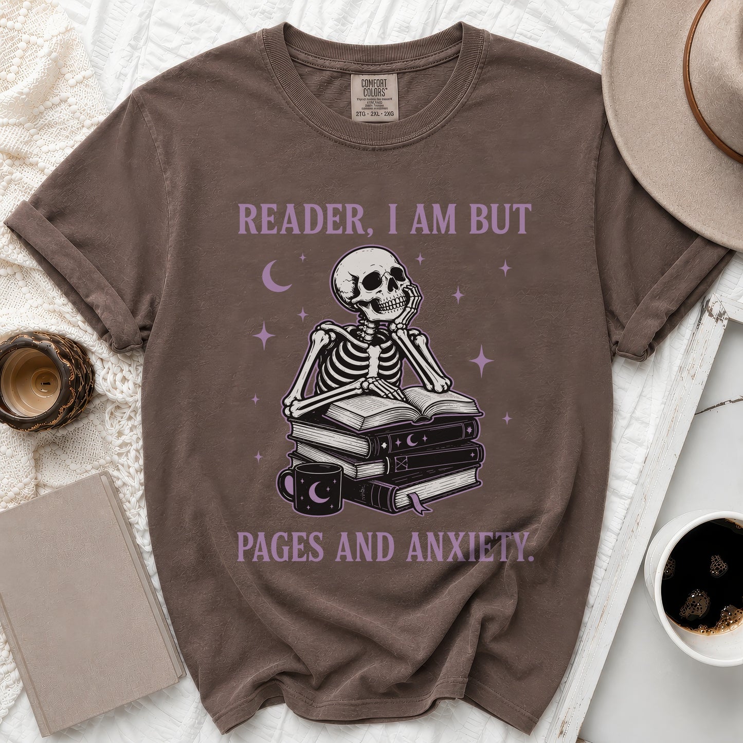 Skeleton sitting on books with text "READER, I AM BUT PAGES AND ANXIETY."