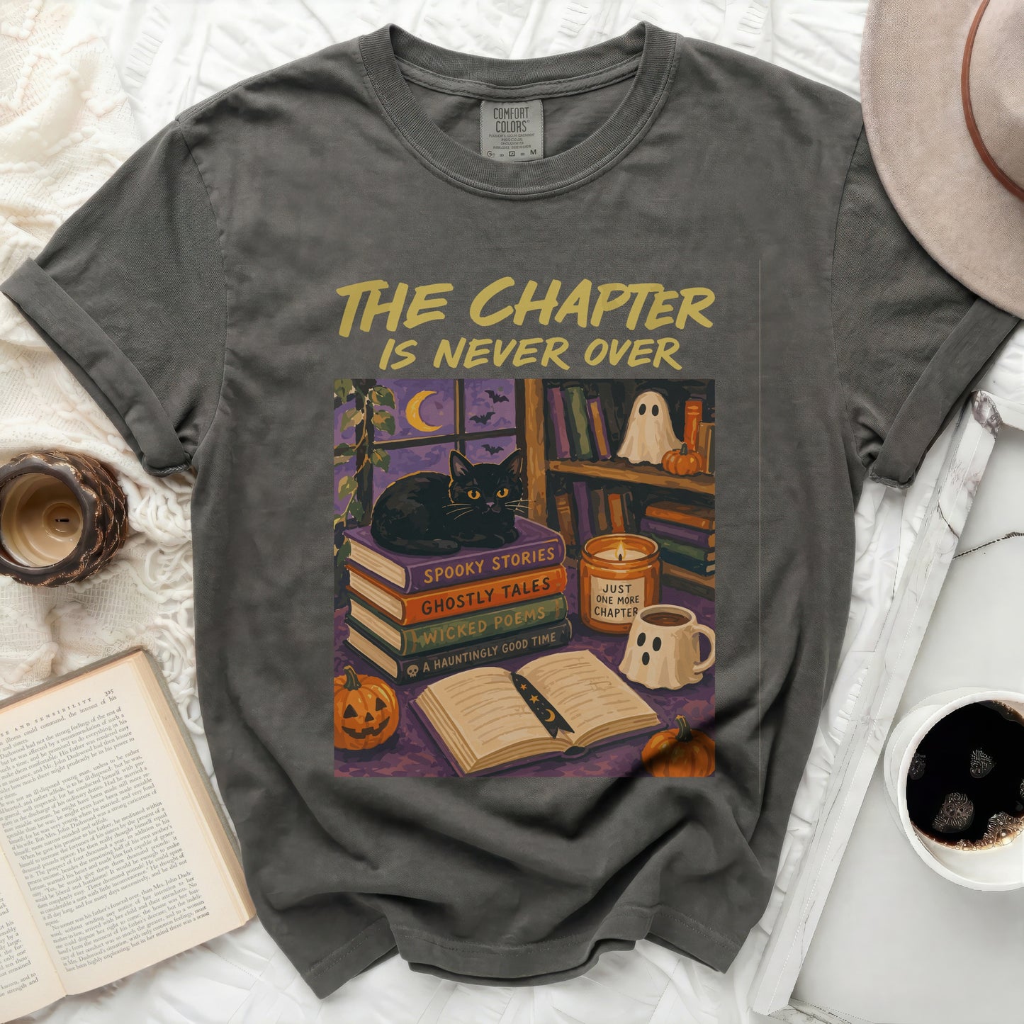 T-shirt with "The Chapter Is Never Over" and Halloween book illustration.