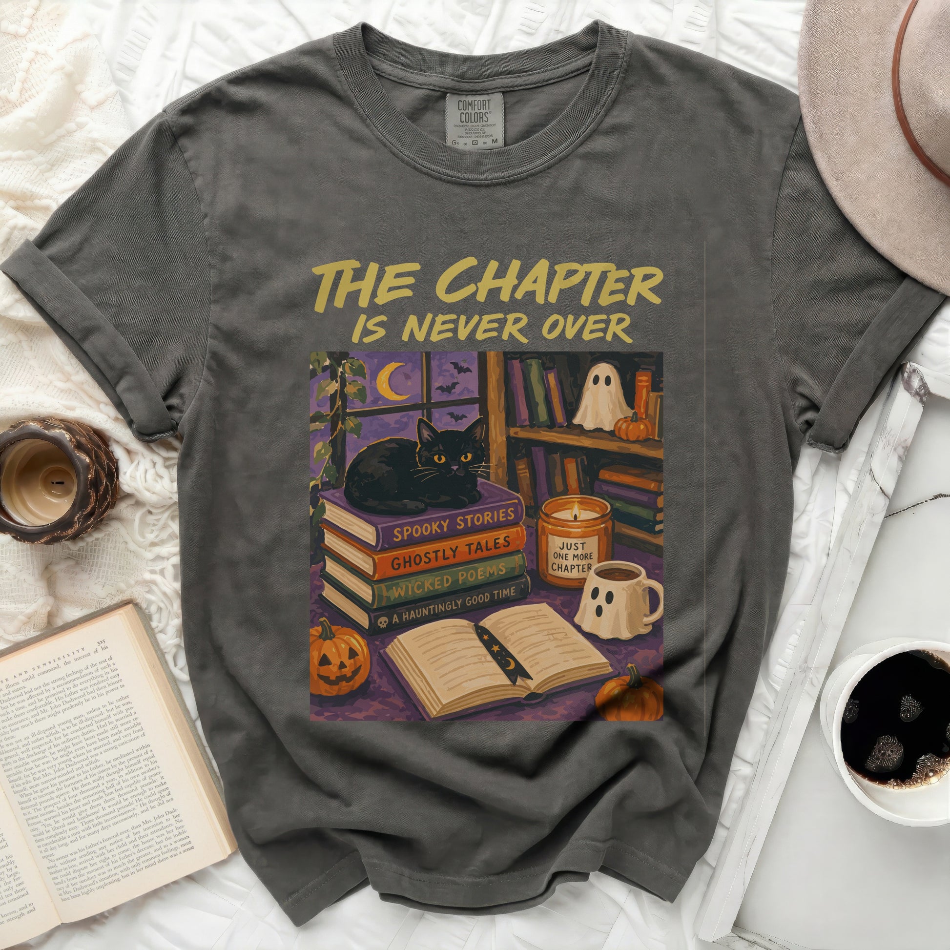 T-shirt with "The Chapter Is Never Over" and Halloween book illustration.