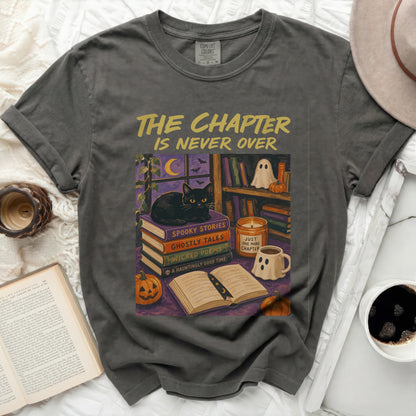 T-shirt with "The Chapter Is Never Over" and Halloween book illustration.