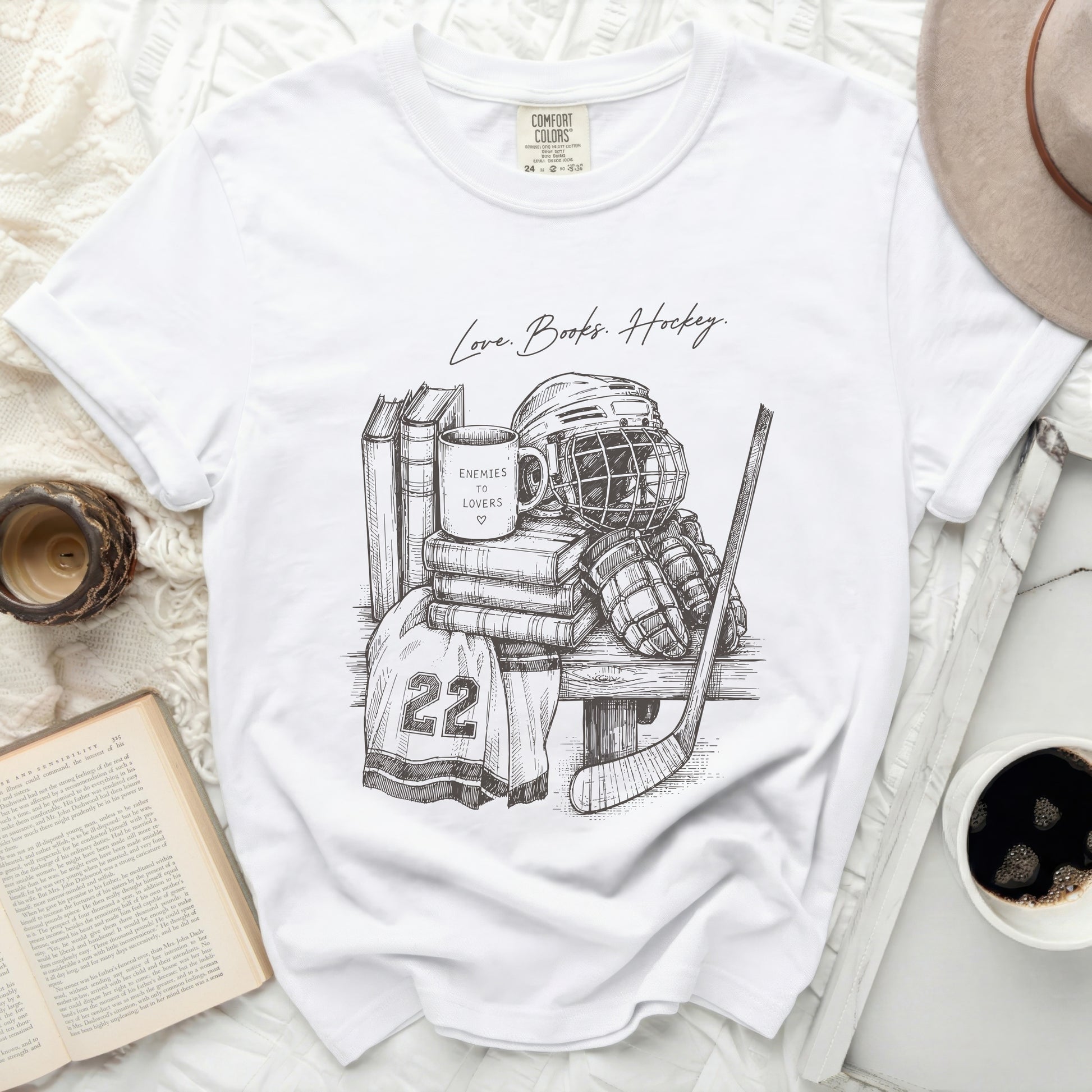 T-shirt with sketch of hockey gear, books, and text "Love. Books. Hockey."