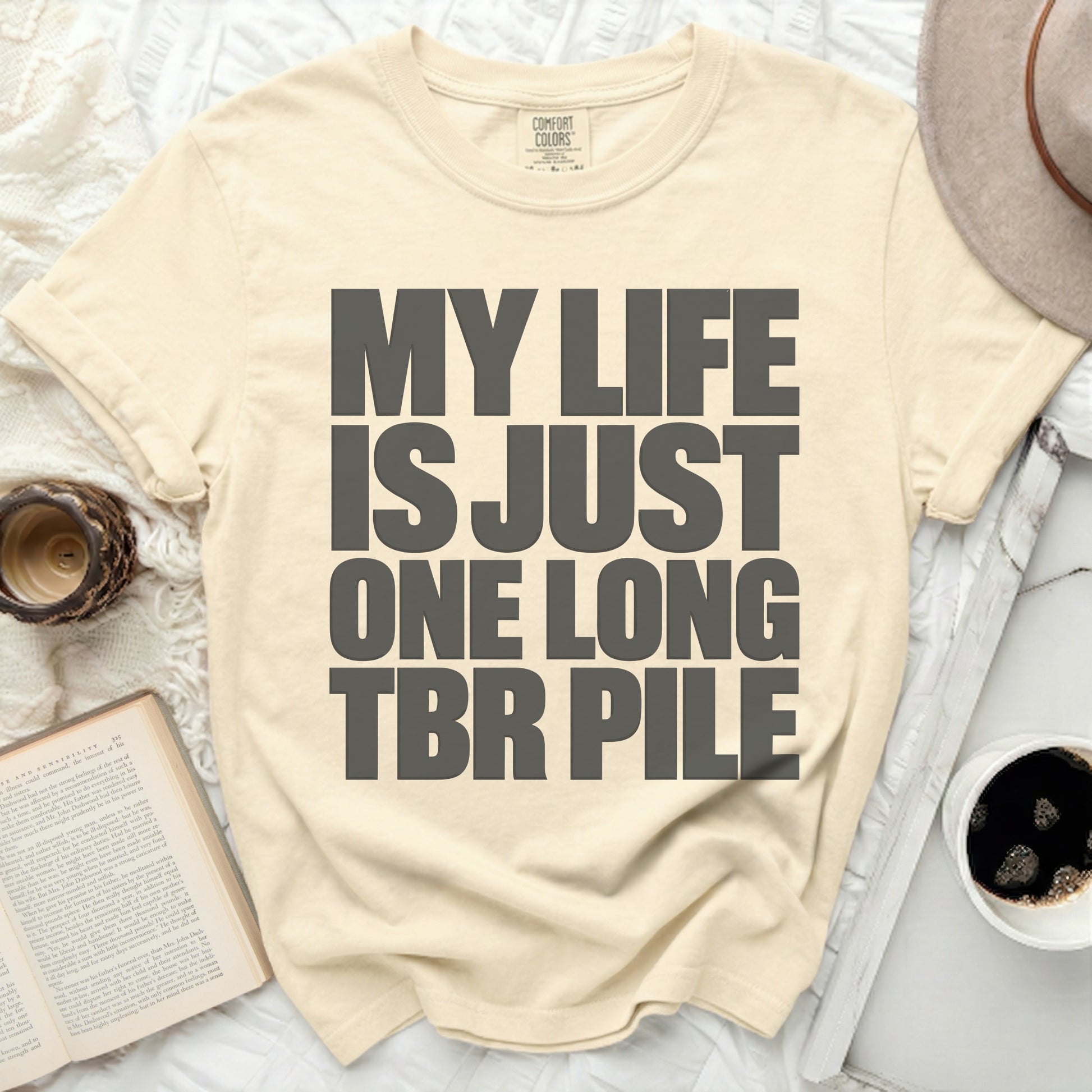 Cream Comfort Colors t-shirt with "MY LIFE IS JUST ONE LONG TBR PILE" text.
