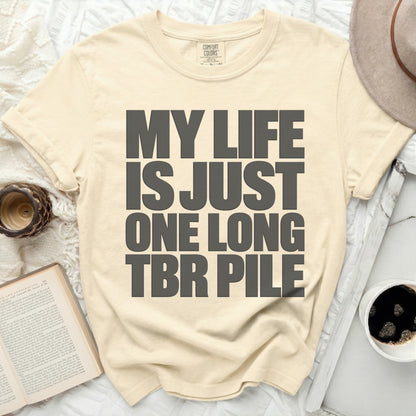 Cream Comfort Colors t-shirt with "MY LIFE IS JUST ONE LONG TBR PILE" text.