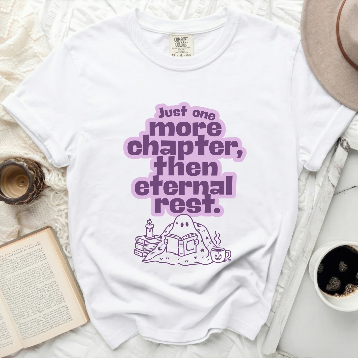 White t-shirt with purple "Just one more chapter, then eternal rest" graphic.