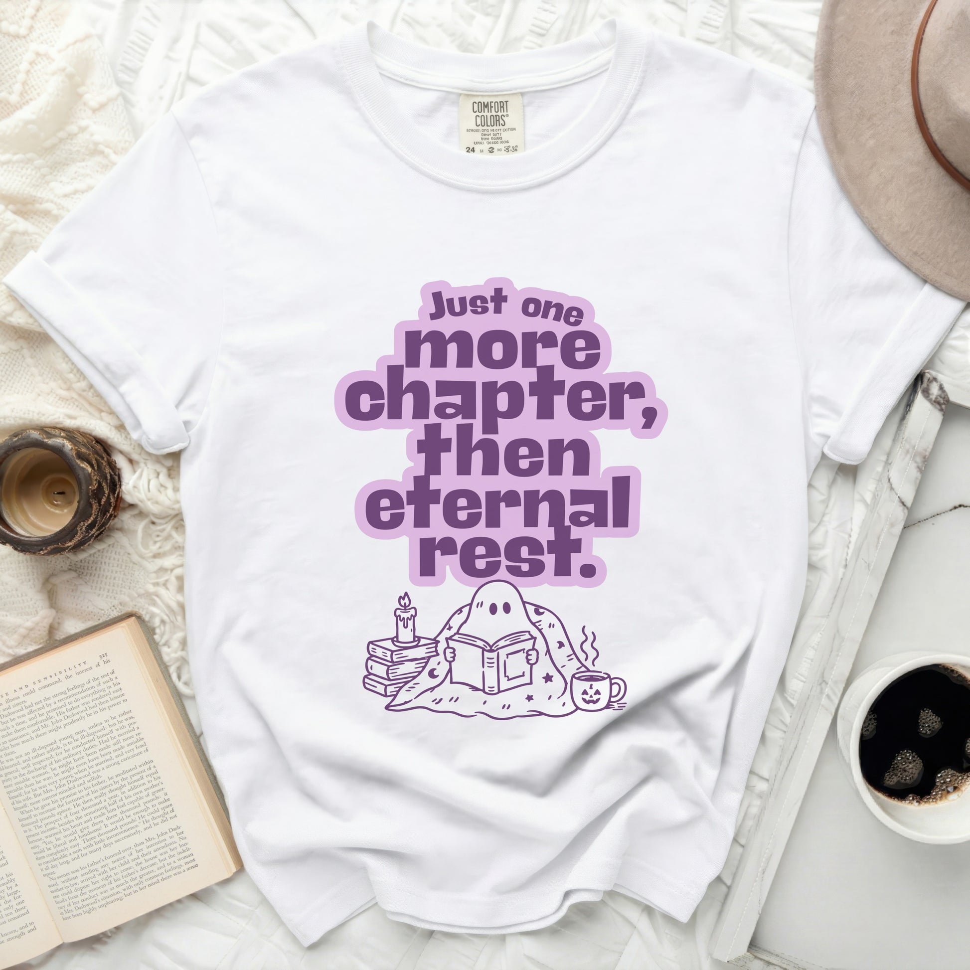 White t-shirt with purple "Just one more chapter, then eternal rest" graphic.