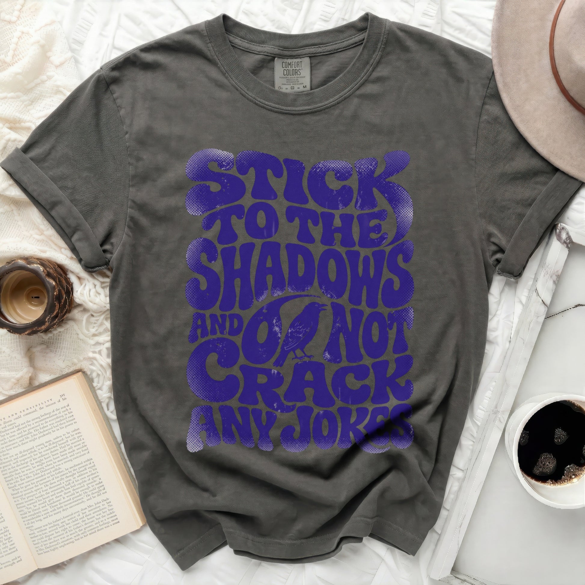 Dark gray t-shirt with purple text "Stick to the shadows and do not crack any jokes".