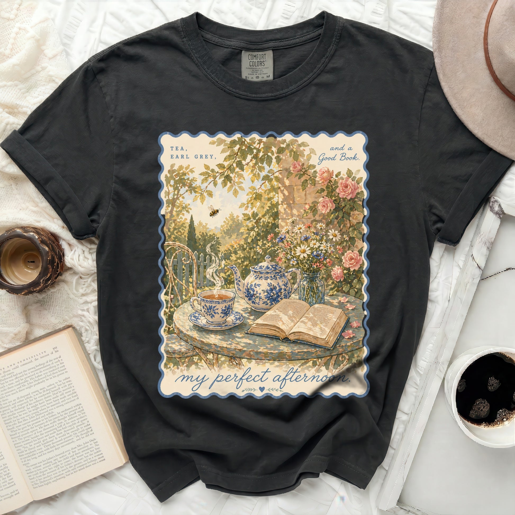 T-shirt with "Tea, Earl Grey, and a Good Book" design and a serene garden scene.