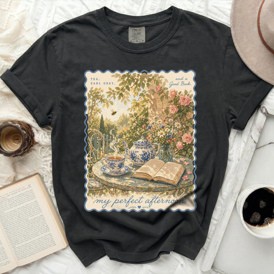 T-shirt with "Tea, Earl Grey, and a Good Book" design and a serene garden scene.