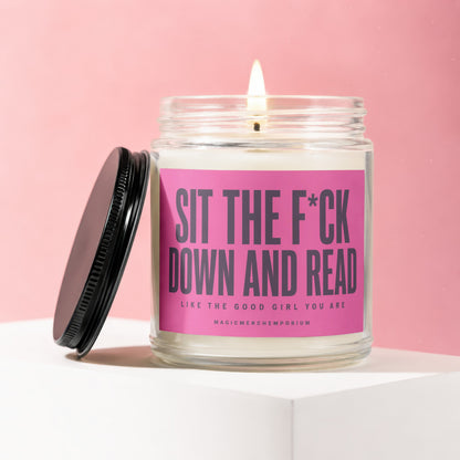 Jar candle with pink label reading "Sit the F*ck Down and Read Like the Good Girl You Are".