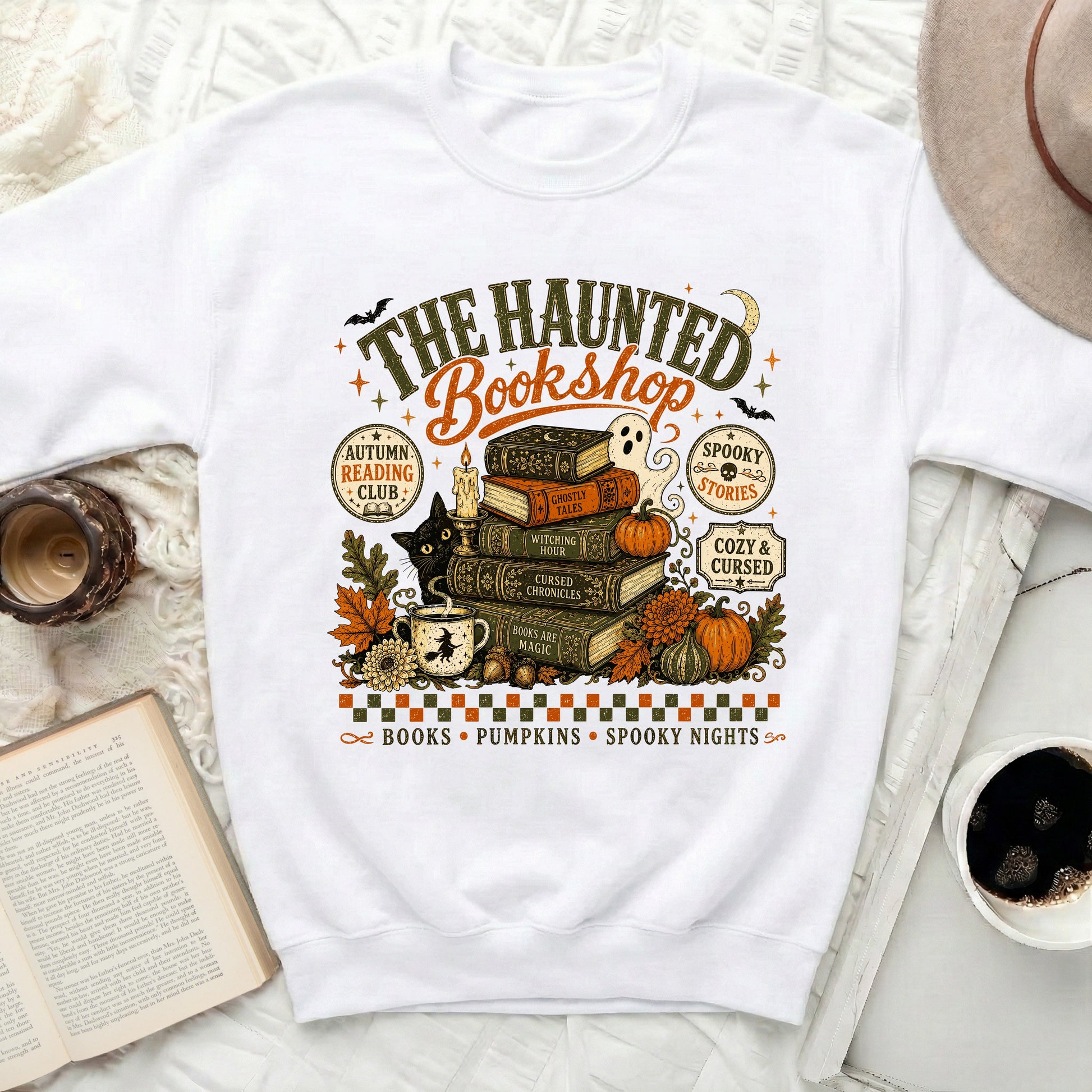 The Haunted Bookshop graphic on a white sweatshirt with Halloween elements.