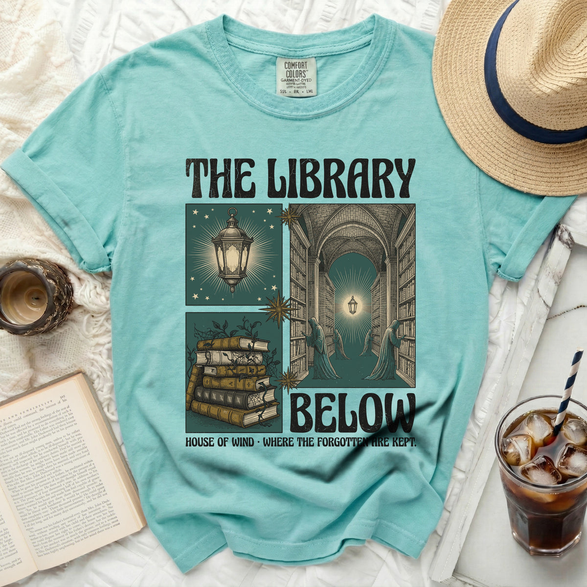 The Library Below graphic tee with vintage illustrations and text.
