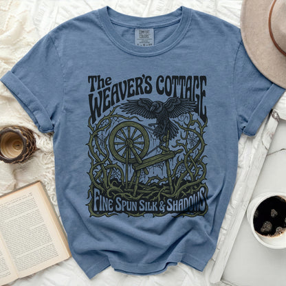 Blue t-shirt with "The Weaver's Cottage" and raven graphic.