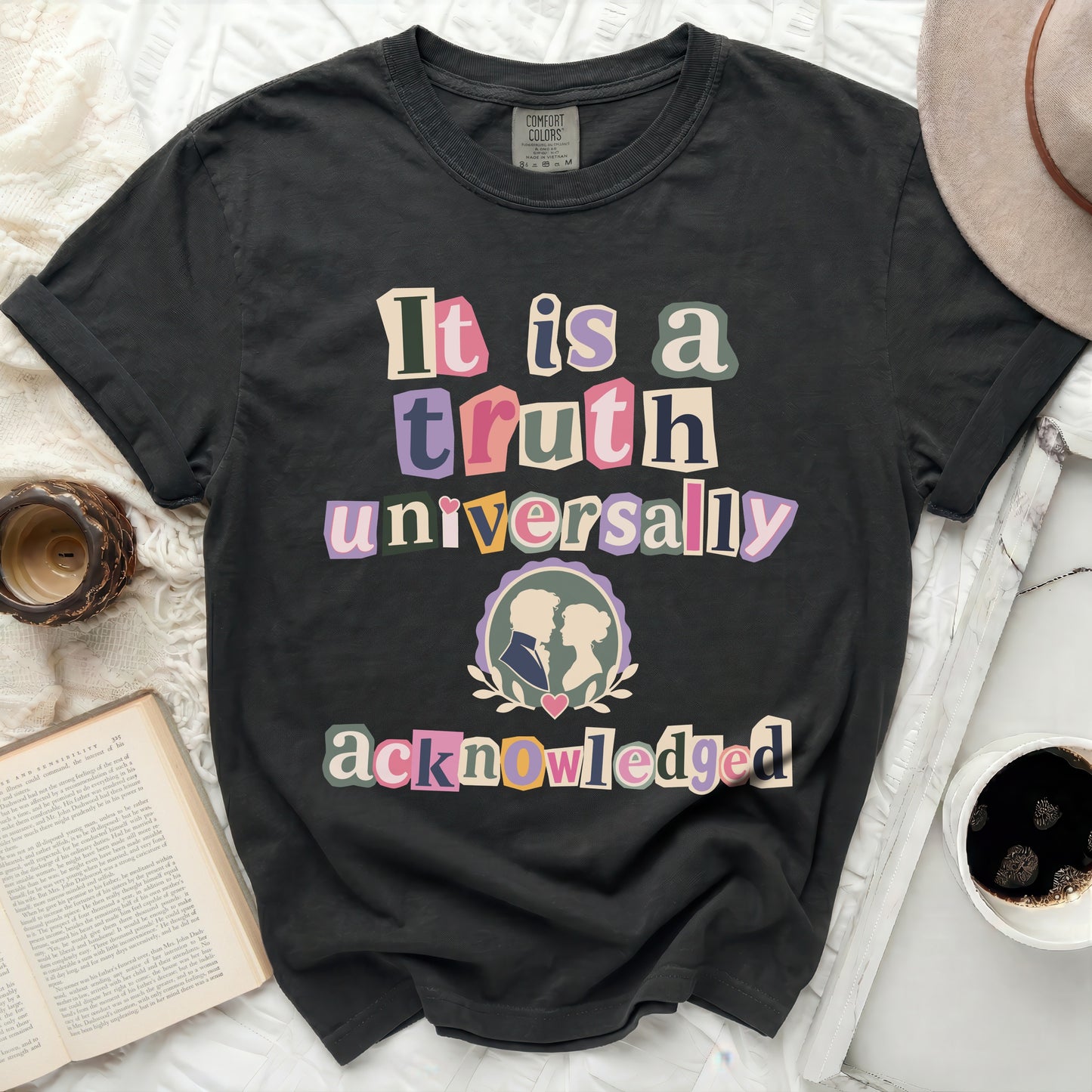 Dark grey Comfort Colors t-shirt, "It is a truth universally acknowledged" text, cameo couple graphic.