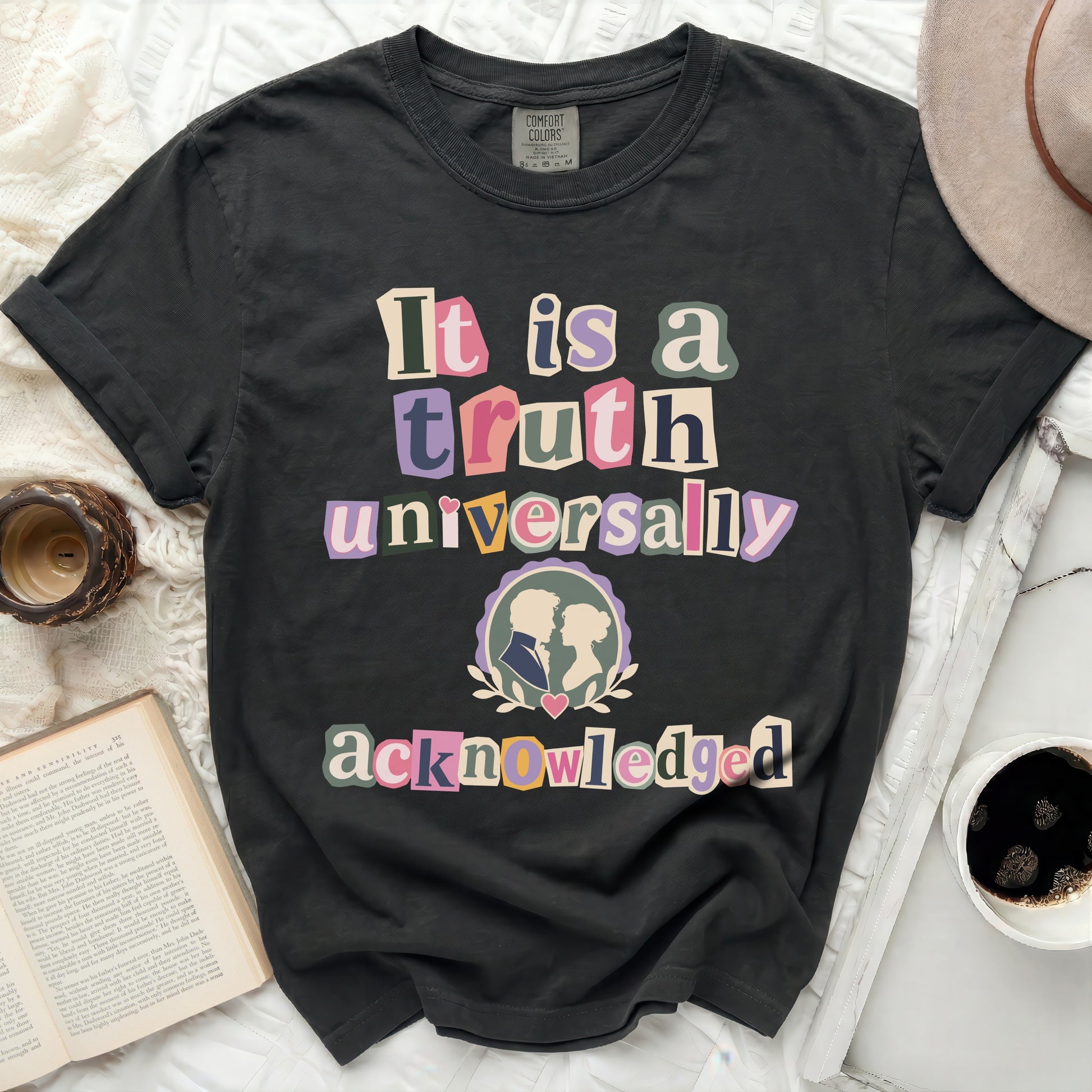 Dark grey Comfort Colors t-shirt, "It is a truth universally acknowledged" text, cameo couple graphic.