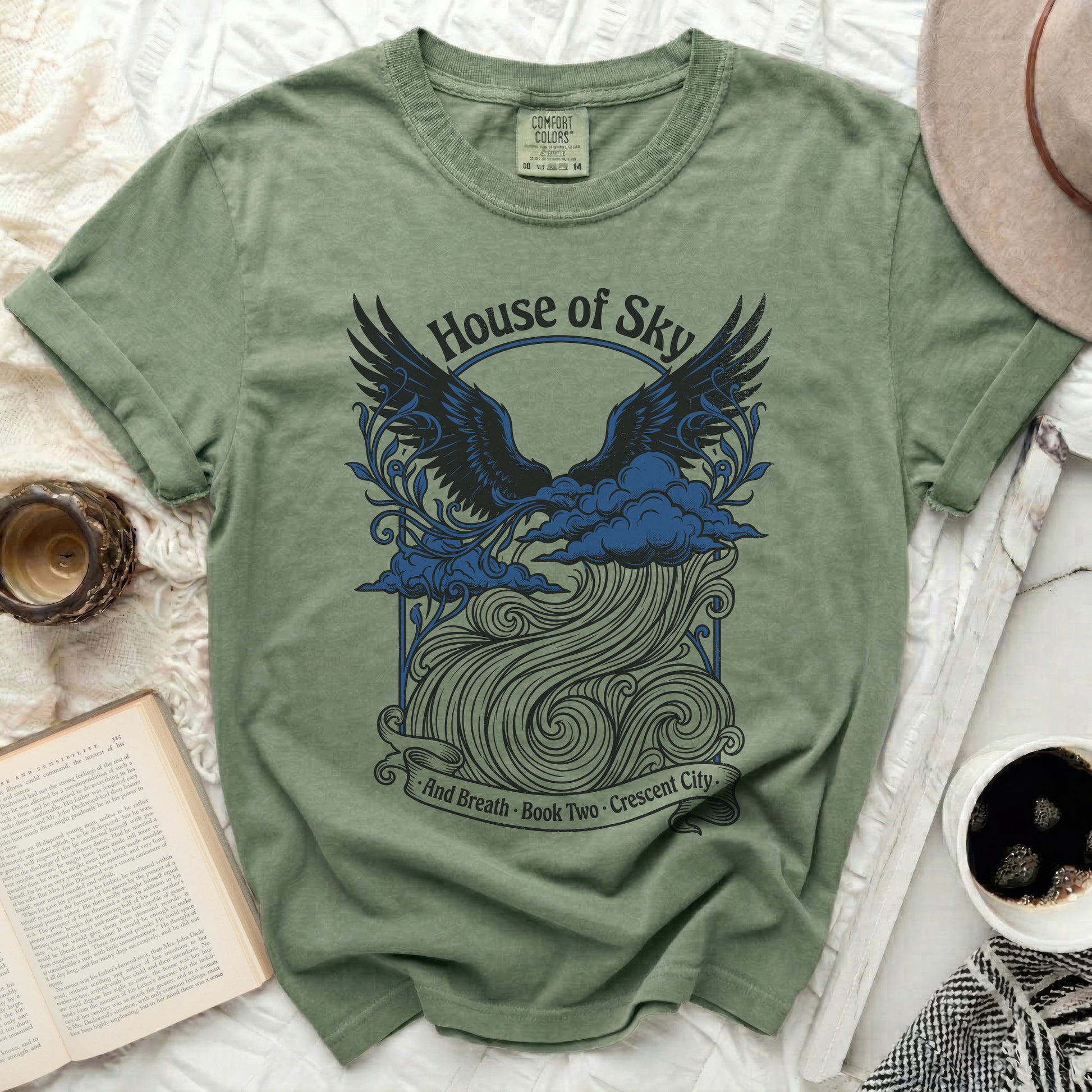 Green t-shirt with "House of Sky" and wings graphic.