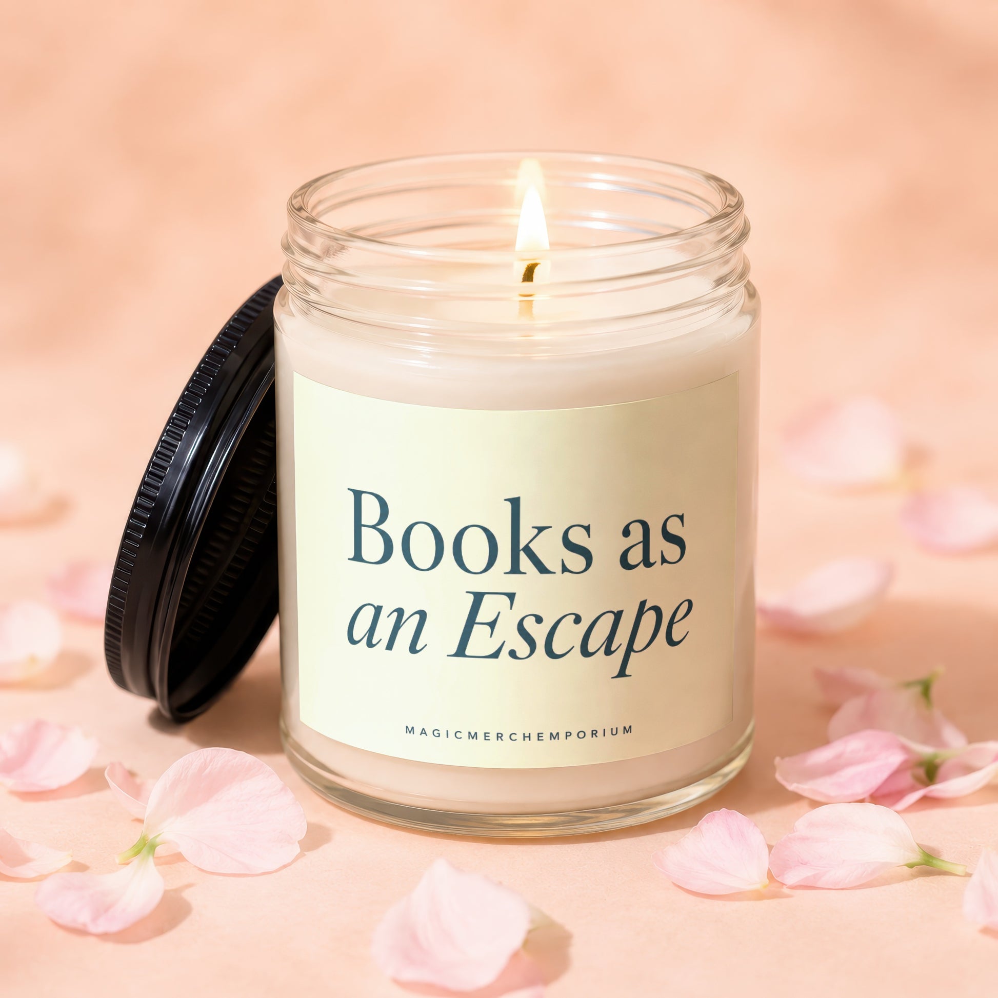 Glass candle with lit wick, lid askew, reads "Books as an Escape".