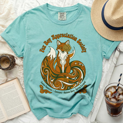 Teal t-shirt with a graphic of a fox, "Fox Boy Appreciation Society," and text.