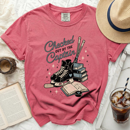 Pink t-shirt with hockey skates, books, and "Checked Out By The Captain" text.