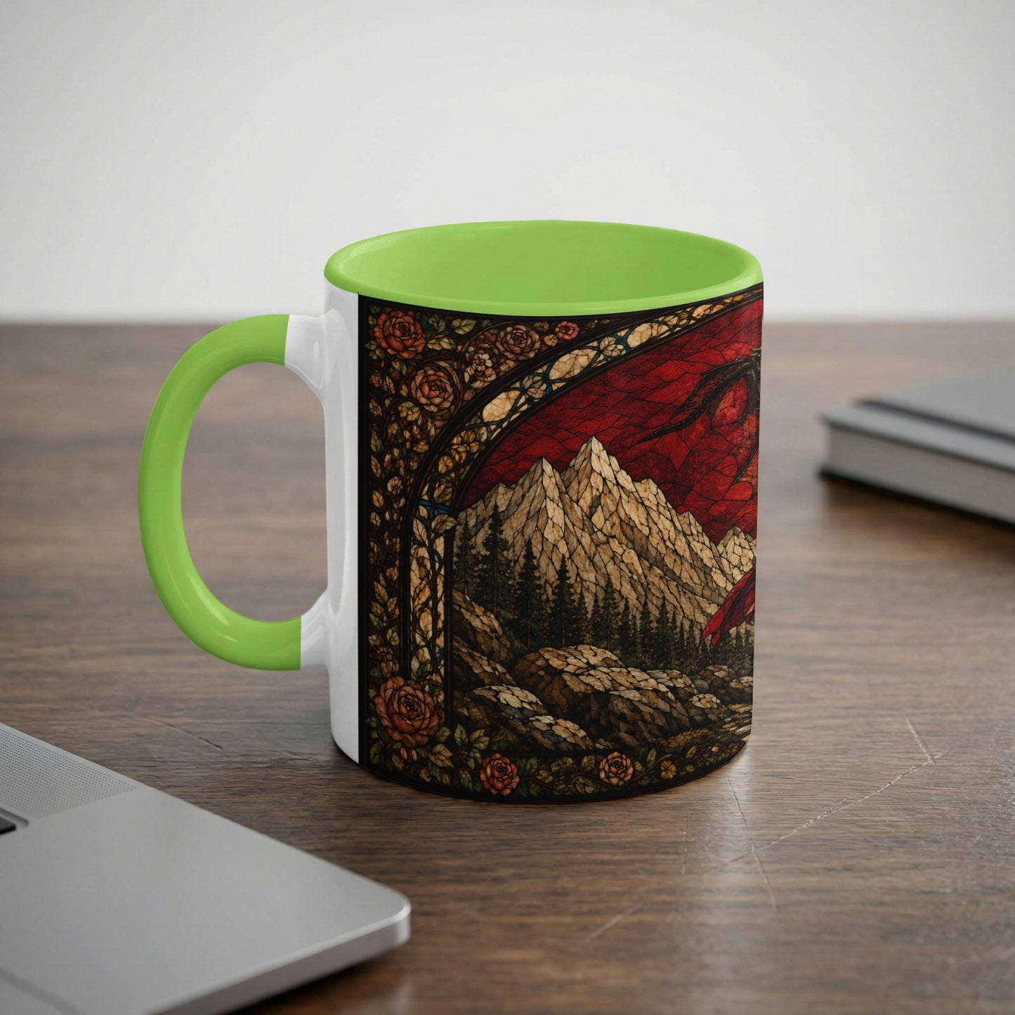White mug with green handle featuring a stained glass dragon, mountains, and roses design.
