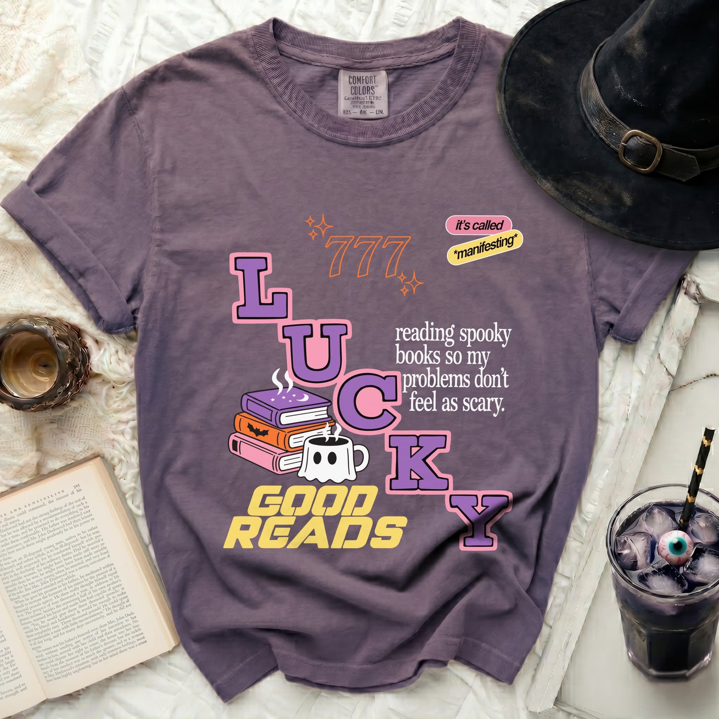 Purple t-shirt with "LUCKY GOOD READS" and spooky book graphic.
