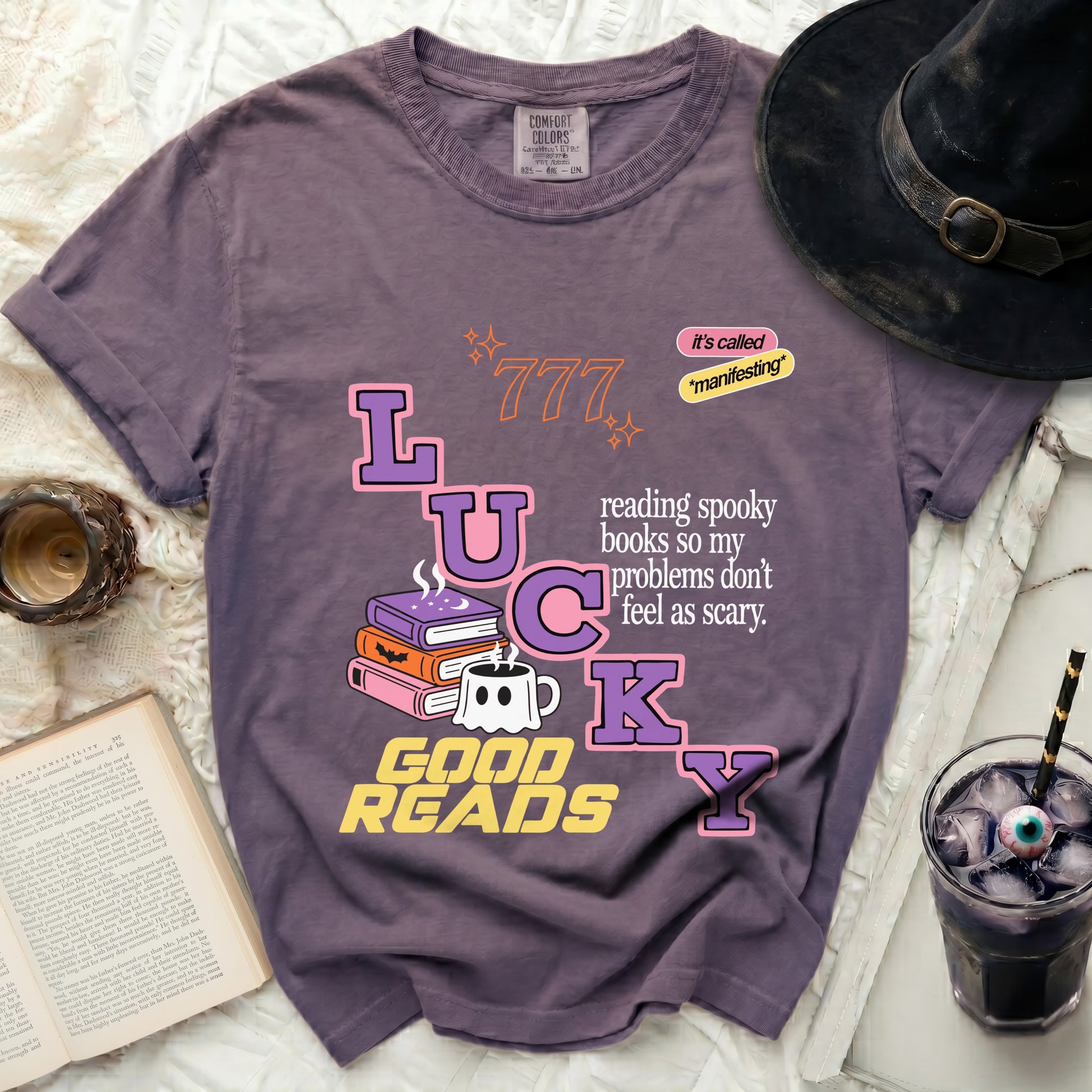 Purple t-shirt with "LUCKY GOOD READS" and spooky book graphic.