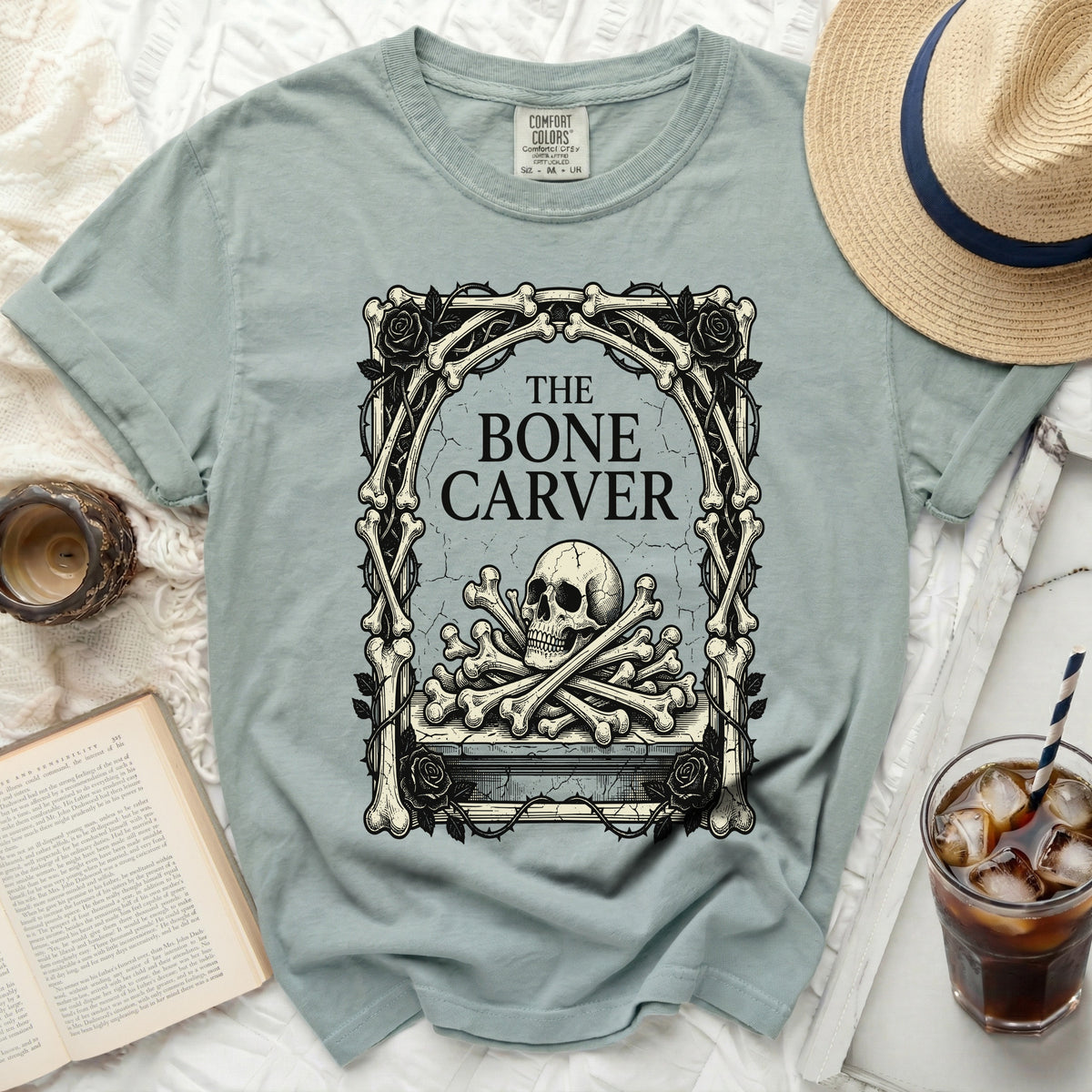 T-shirt with graphic of skull and bones, "The Bone Carver" text