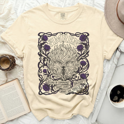 Cream t-shirt with "AMREN" and wolf-like fire design, flowers, and text.