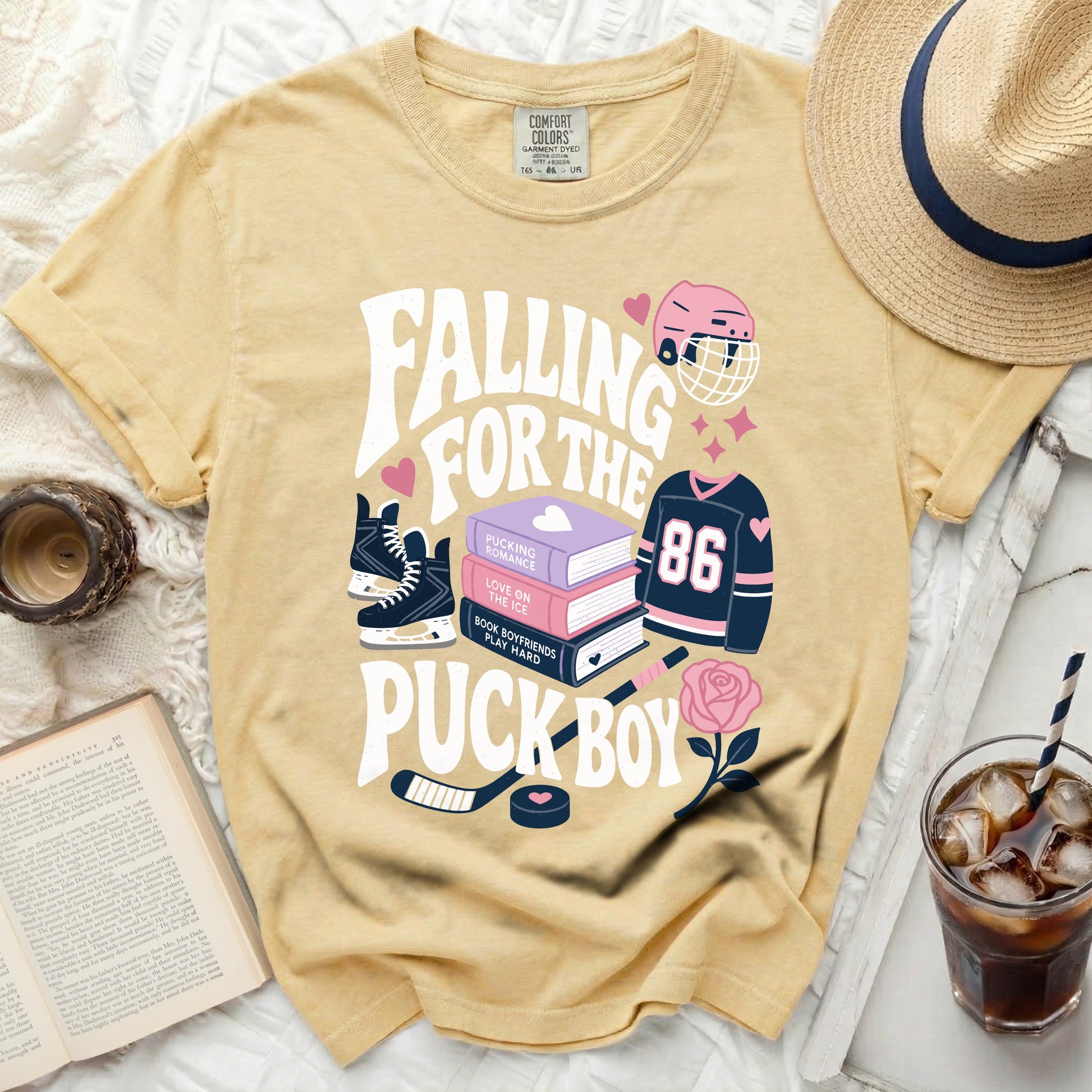 T-shirt with "Falling for the Pucking Boy" text and hockey graphics.