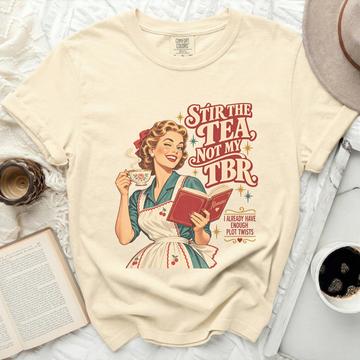 Woman winks holding tea, reading book with text "Stir the tea, not my TBR".