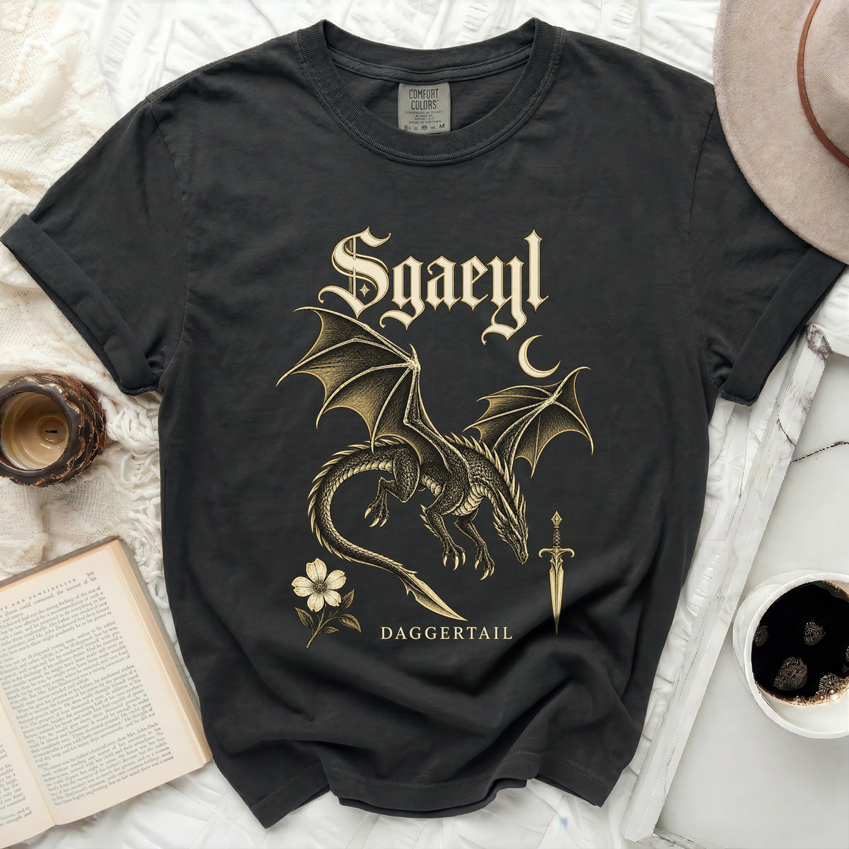 Black t-shirt with a gold dragon, sword, flower, and moon design.