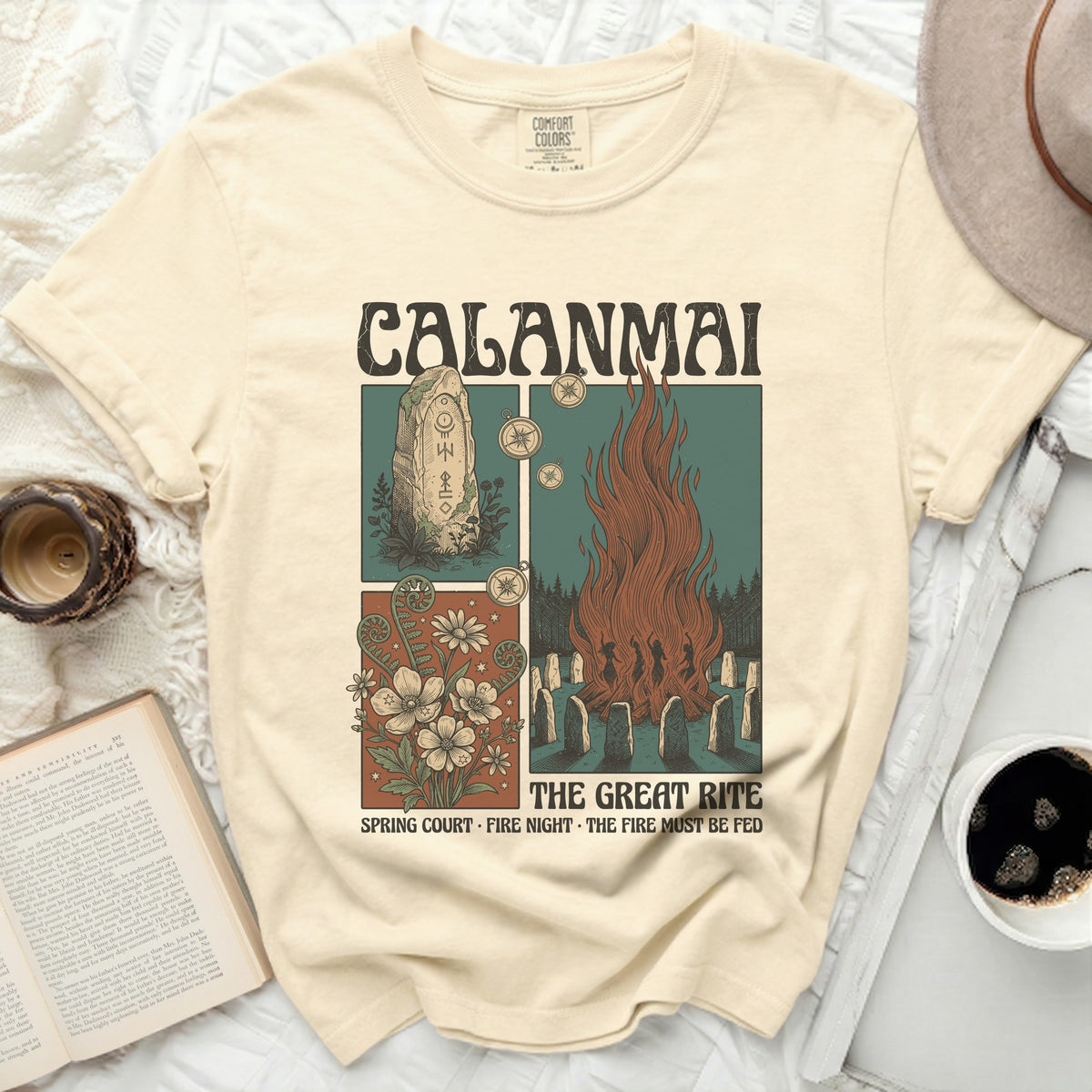 Calamai t-shirt with a graphic of a bonfire, runes, and flowers.