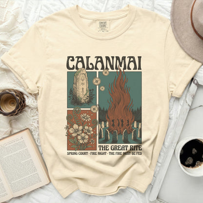 Calamai t-shirt with a graphic of a bonfire, runes, and flowers.
