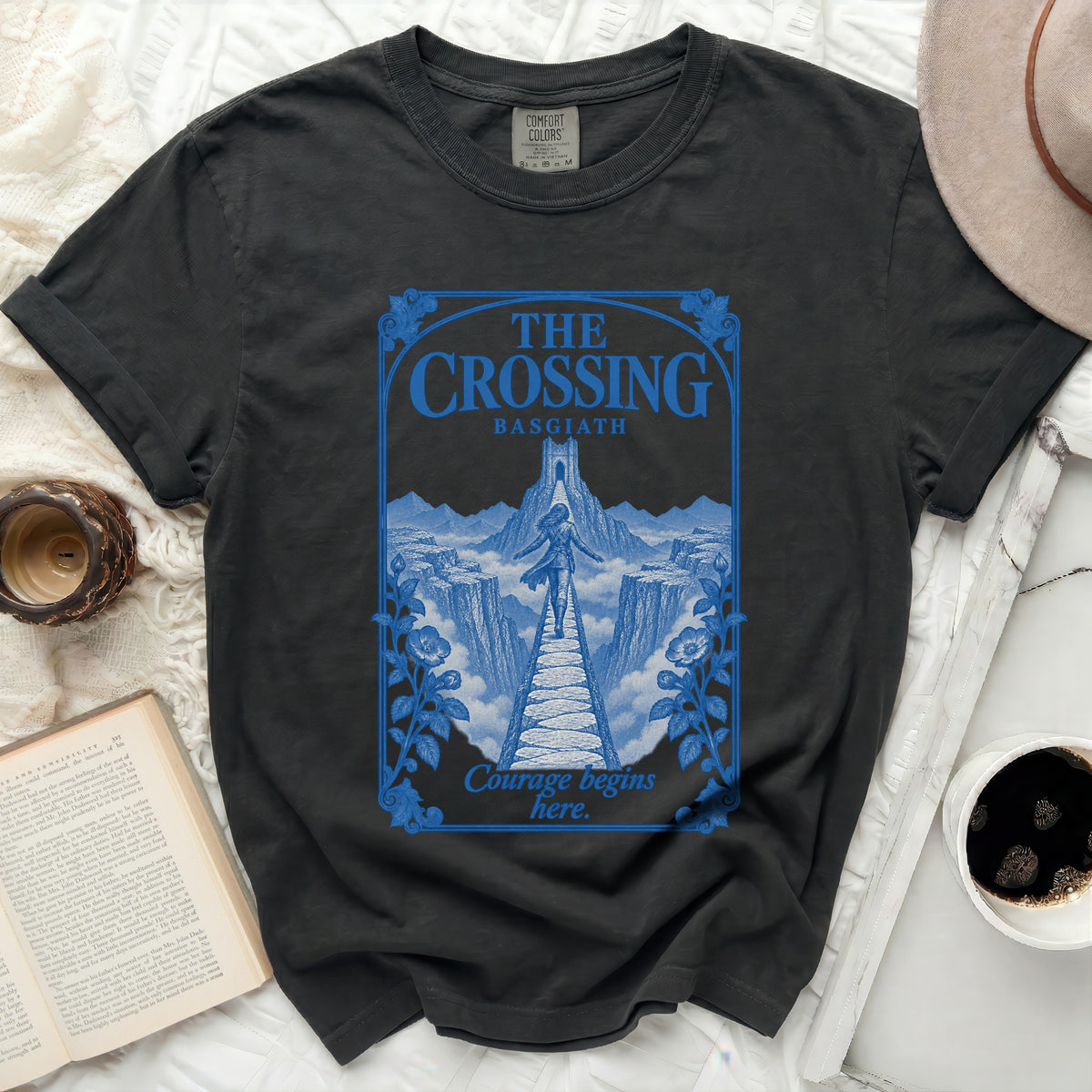 Dark grey t-shirt with blue "The Crossing Basgiath Courage begins here" graphic.