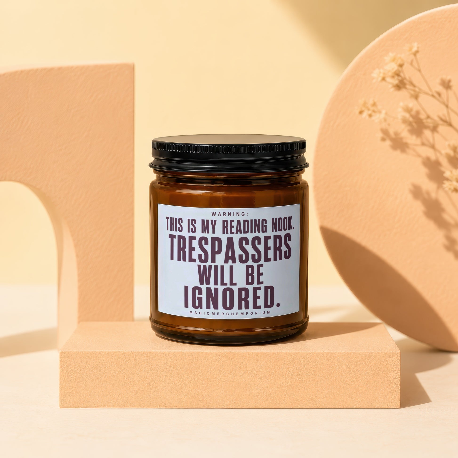 Amber candle with a black lid reading "This Is My Reading Nook. Trespassers Will Be Ignored."