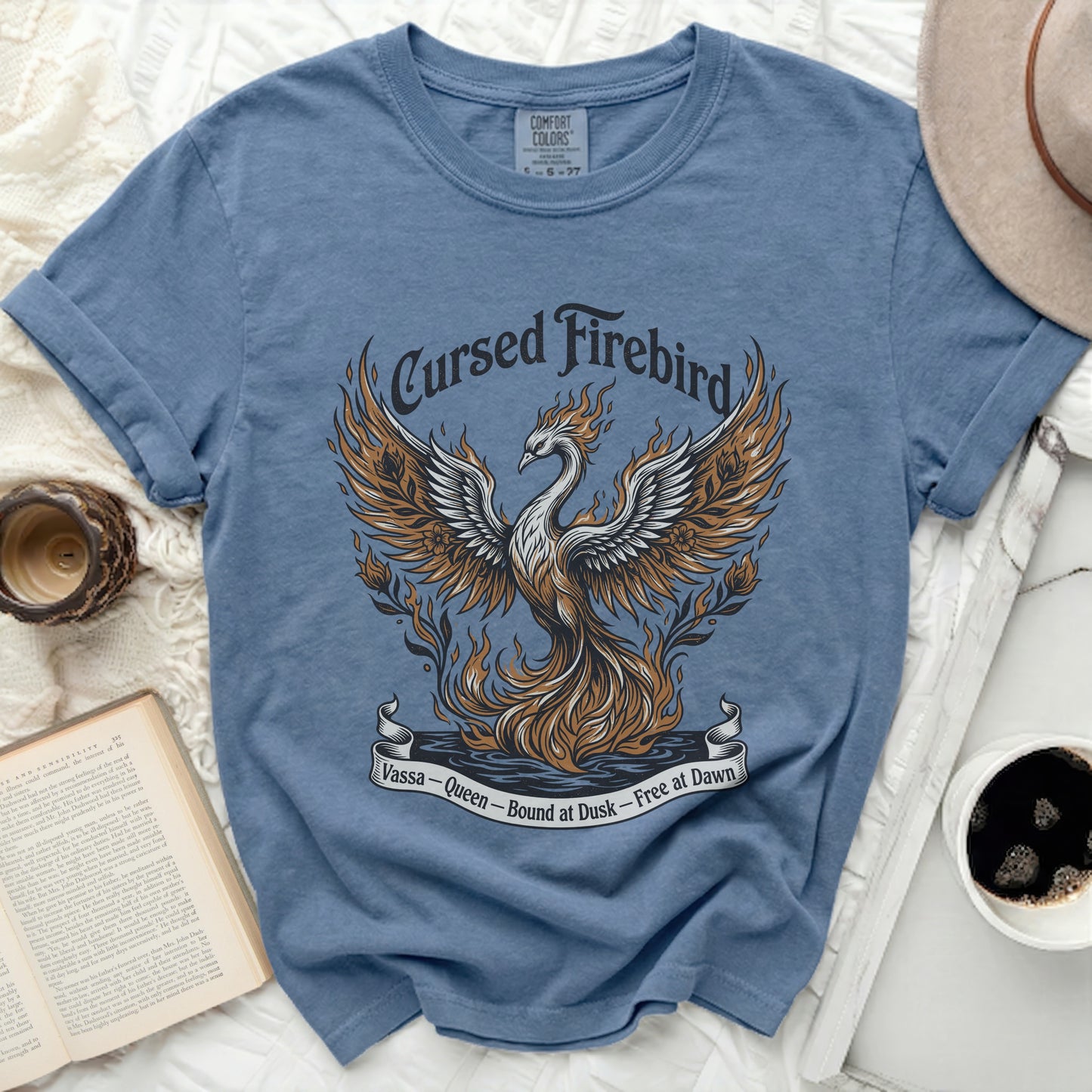 Blue t-shirt with a graphic of a fiery phoenix and text "Cursed Firebird Vassa - Queen - Bound at Dusk - Free at Dawn".