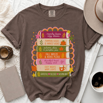 Brown t-shirt with stacked books graphic and fall-themed text.