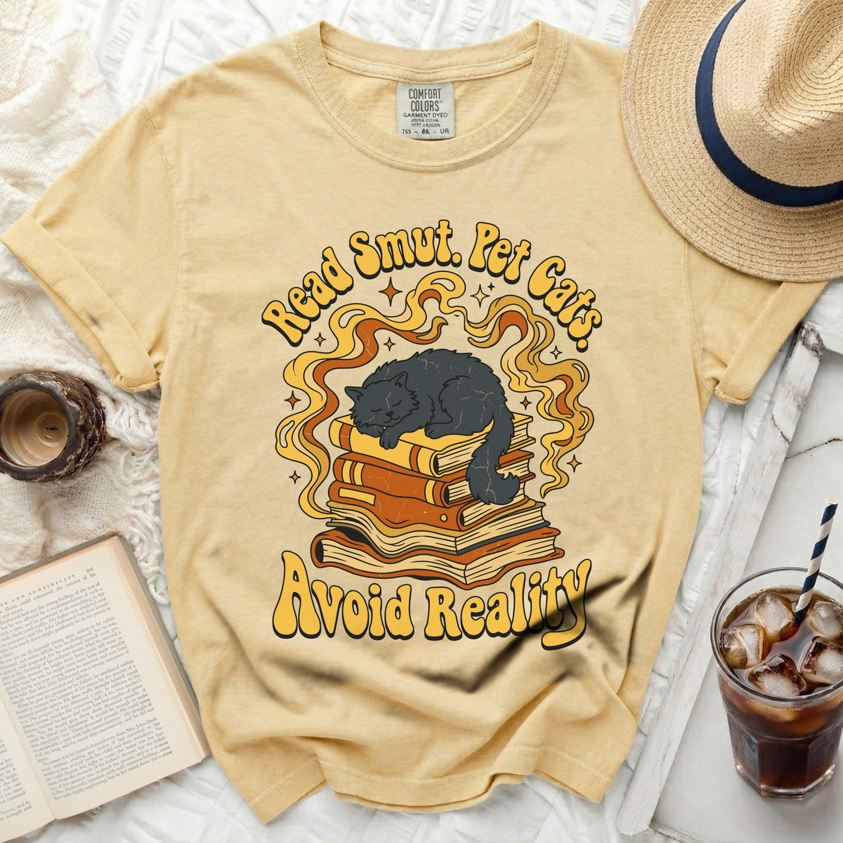 Yellow graphic t-shirt with cat on books and "Read Smut. Pet Cats. Avoid Reality."
