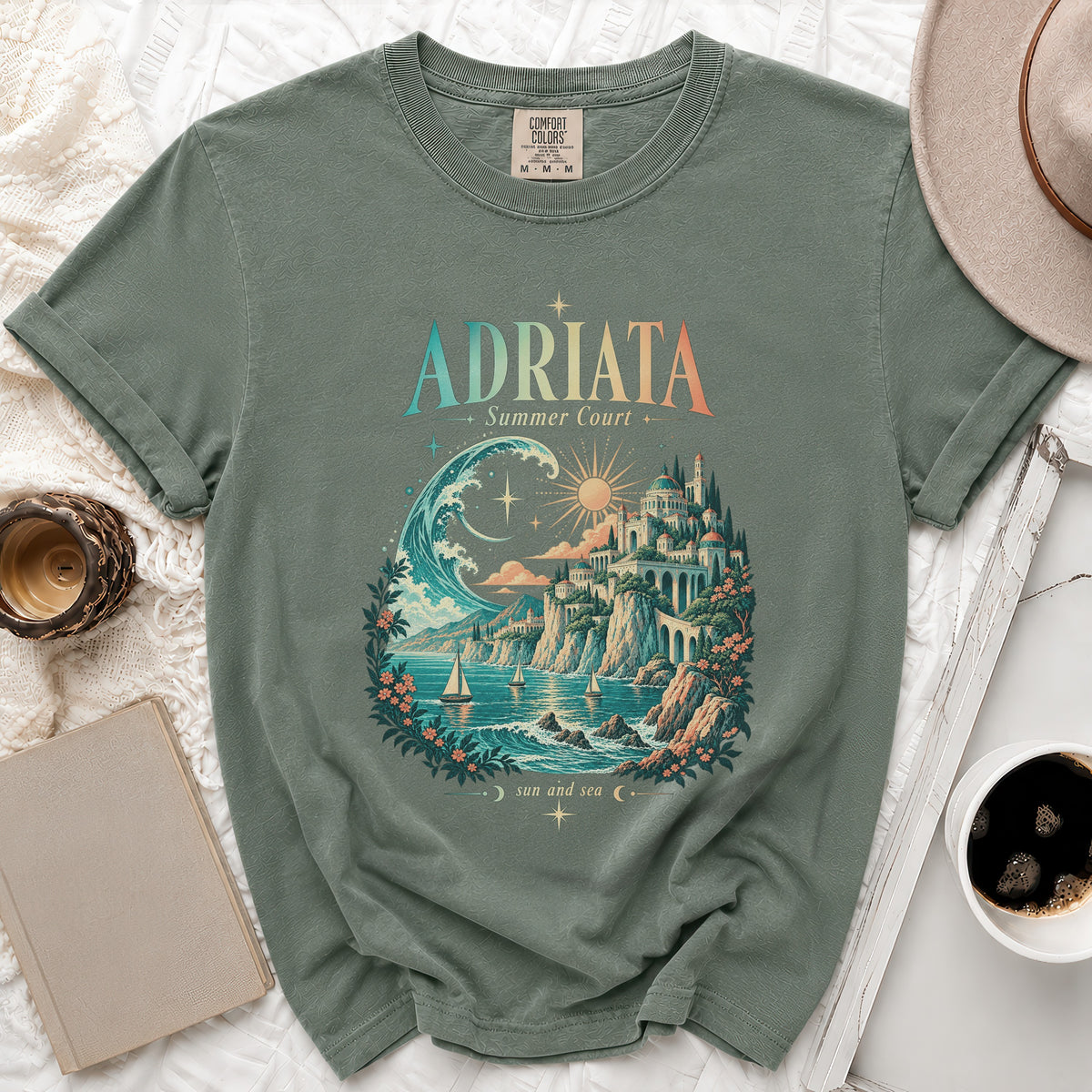 T-shirt with "ADRIATA Summer Court" and "sun and sea" text and coastal landscape design.