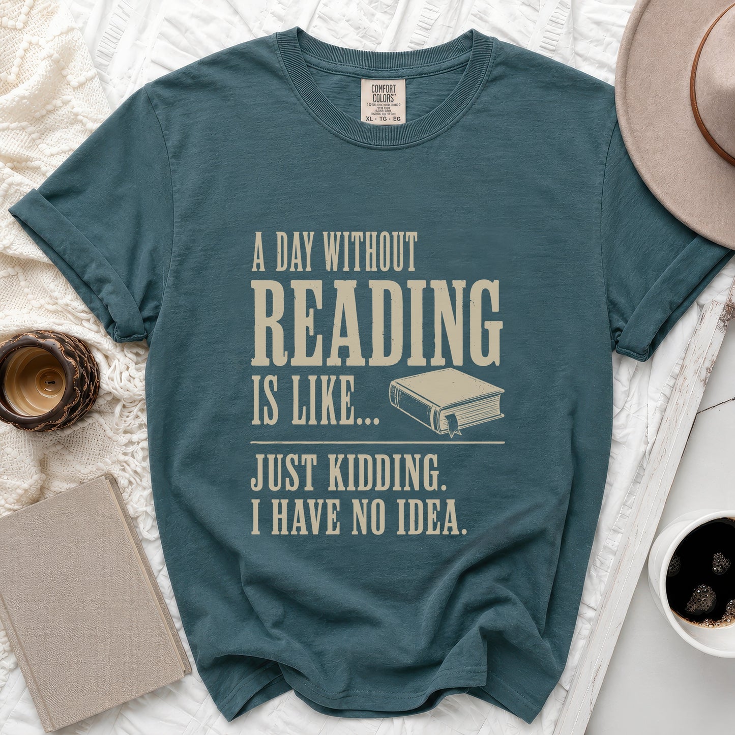 Teal t-shirt with text "A day without reading is like... Just kidding. I have no idea."