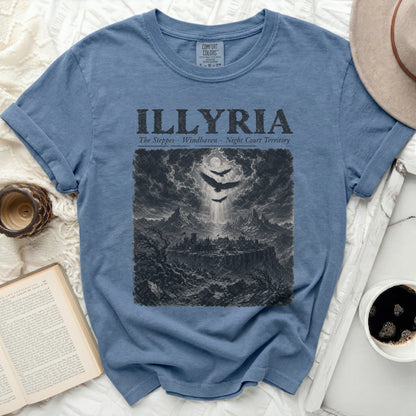 Blue t-shirt with "ILLYRIA" and a dark, engraved landscape of a city with mountains.
