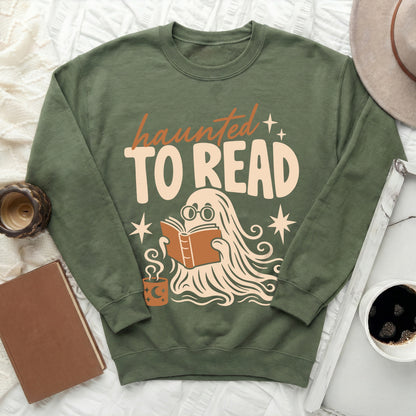 Green sweatshirt with "haunted TO READ" text and a ghost reading a book.