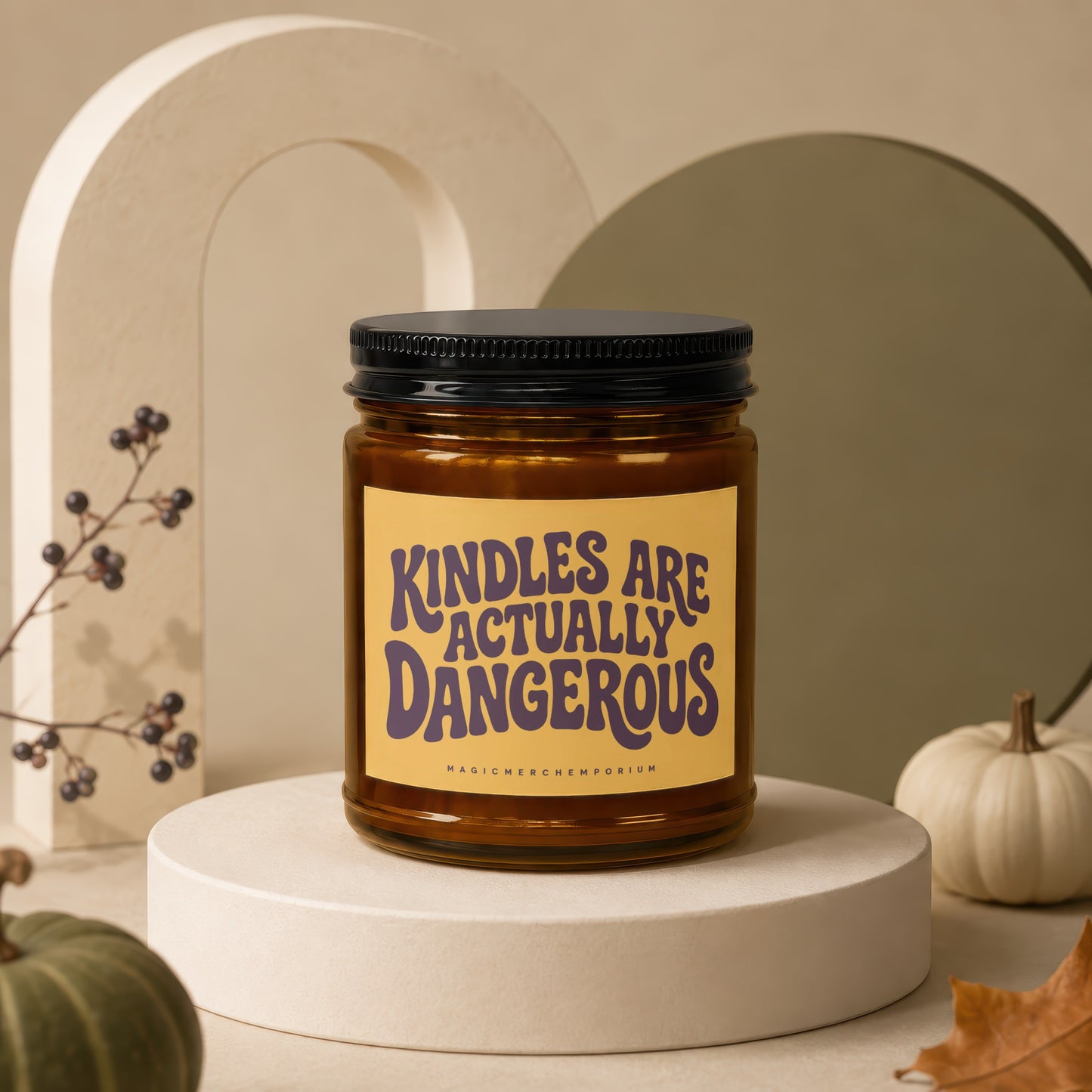 Amber candle in a jar with a black lid, label reads "Kindles Are Actually Dangerous."